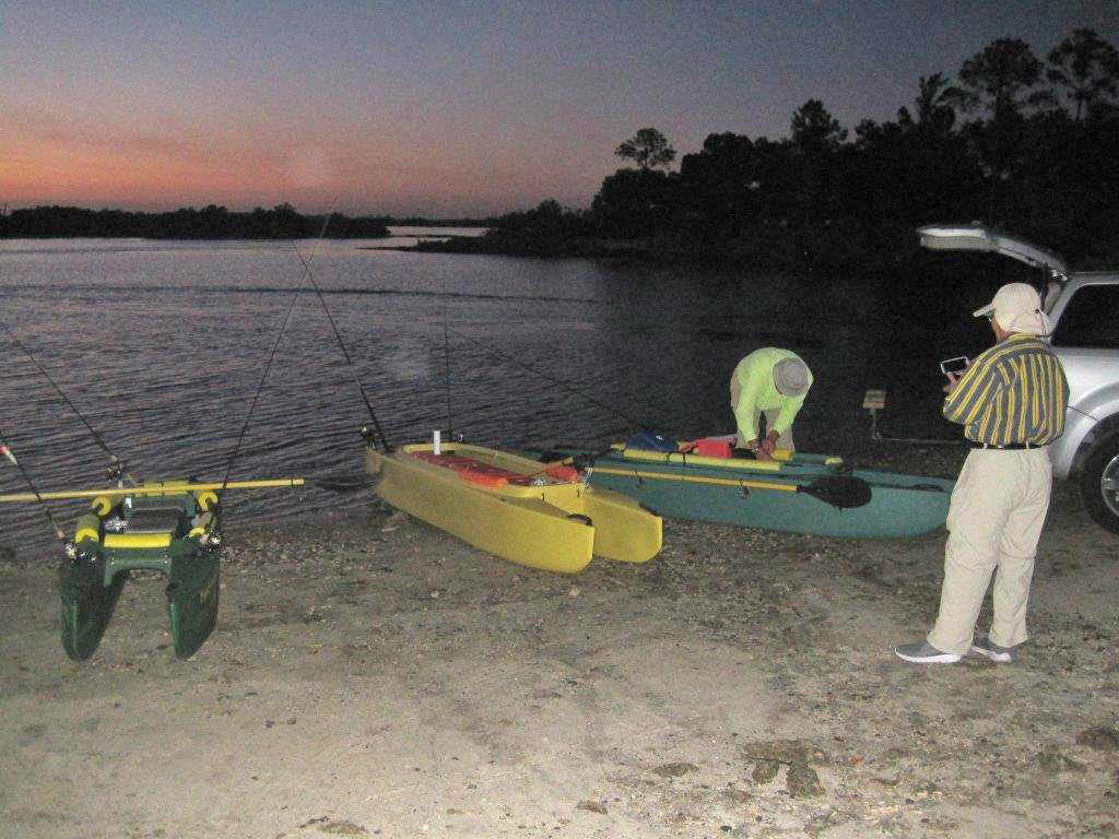 Jai-standing-on-the-beach-next-to-Art-and-their kayaks
