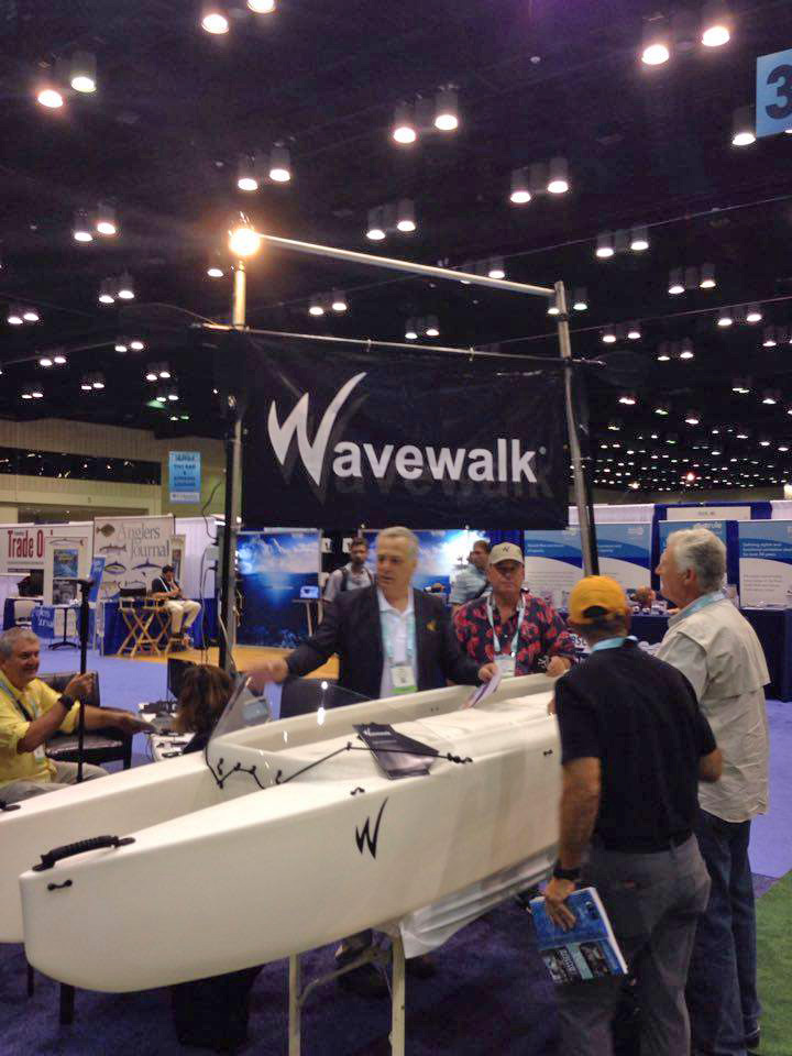 Larry and Yoav standing next to the Wavewalk 700 Microskiff