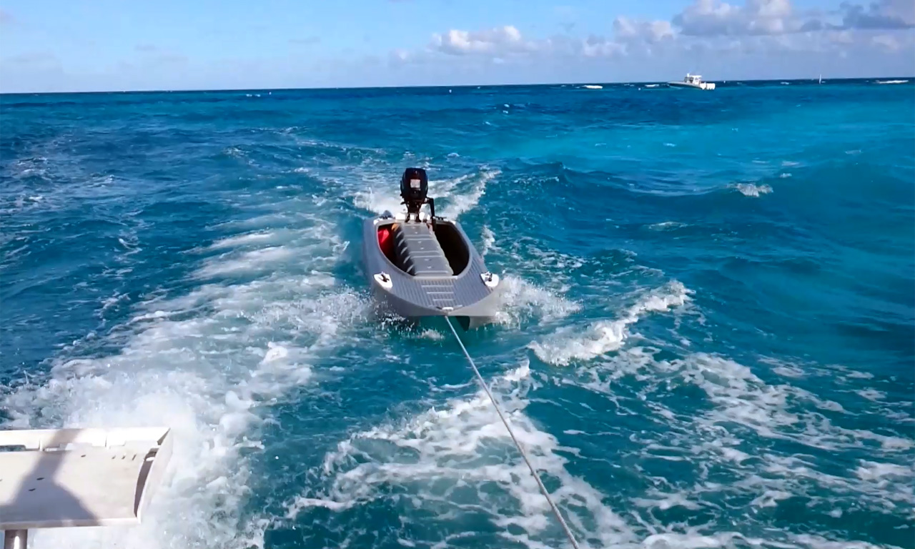 boat tender being towed behind a big boat - Wavewalk S4