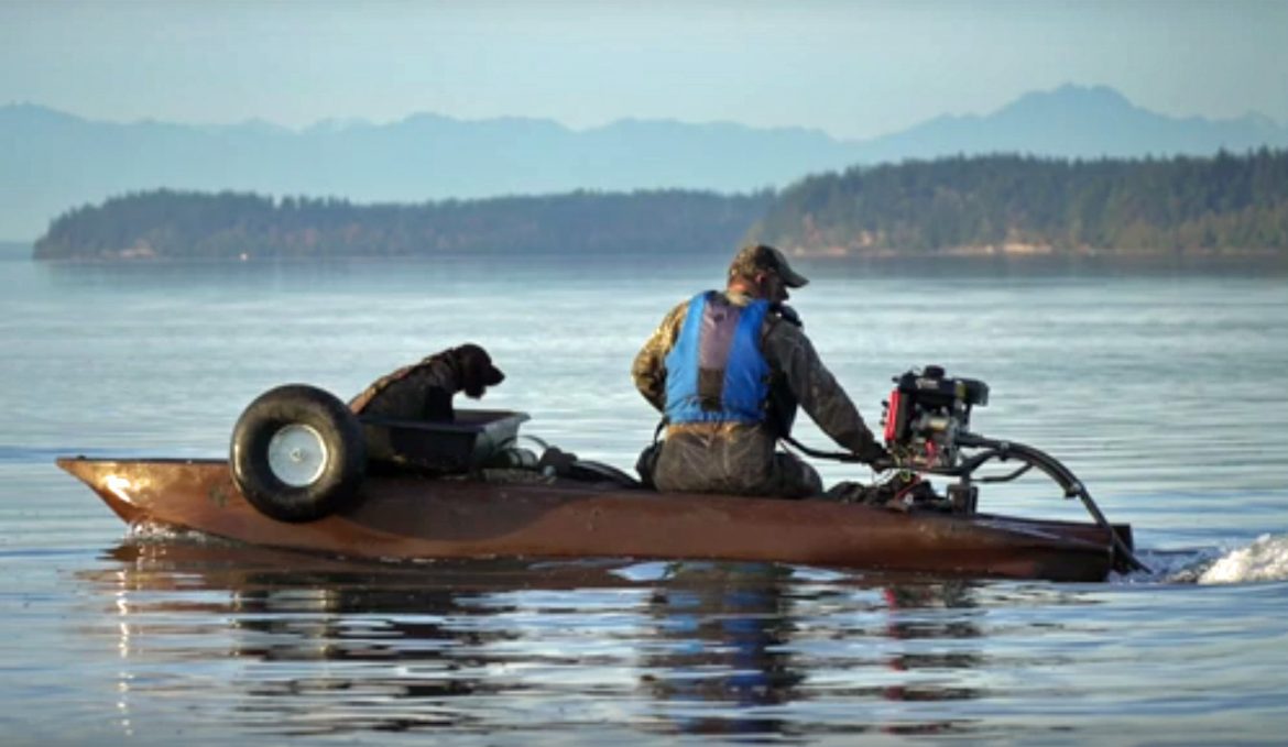 S4 duck hunting boat with surface drive (mud motor) and retriever dog
