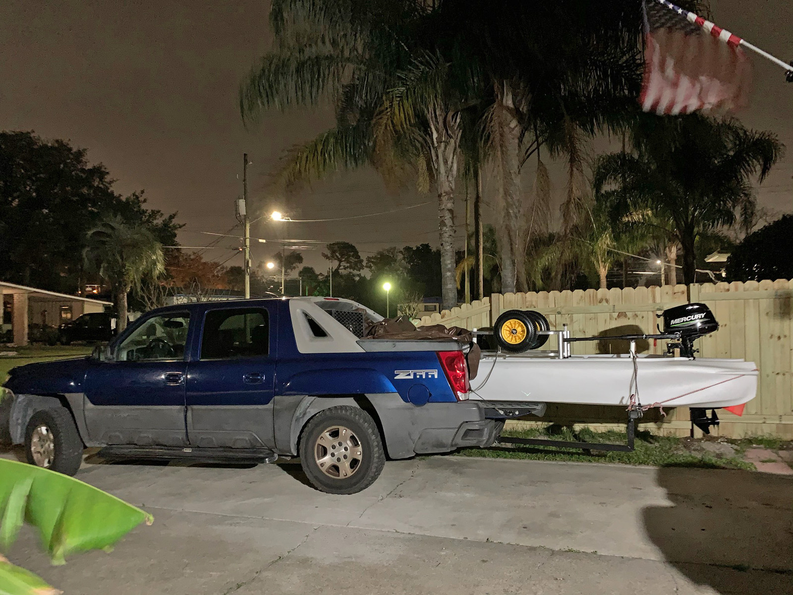 Pickup truck carrying S4 motor kayak skiff on truck bed