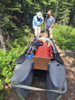 portaging carrying a Wavewalk S4 portable boat over rugged terrain