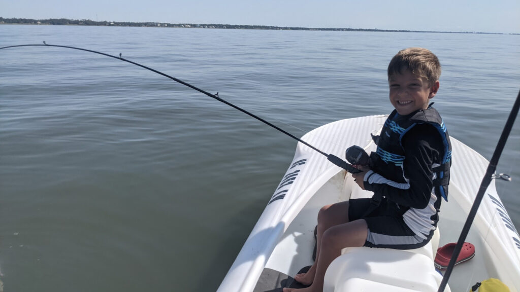 boy fishing out of hs dad's S4 microskiff