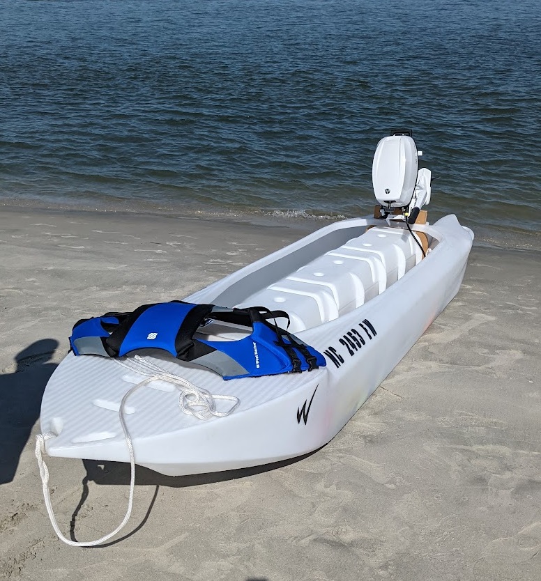 S4 microskiff beached 6 HP Tohatsu outboard motor, white