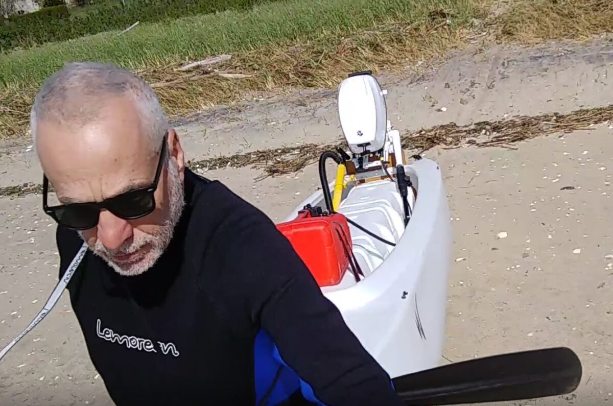 Boater carries his W720 Kayak Skiff on the beach
