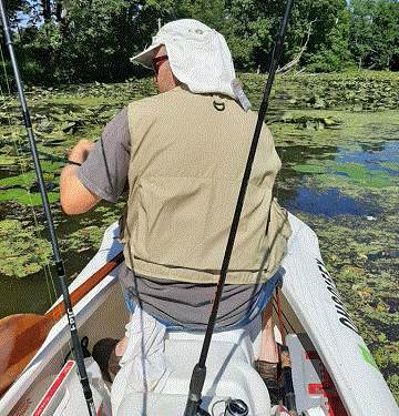 fishing buddy in the cockpit of a two-person fishing boat