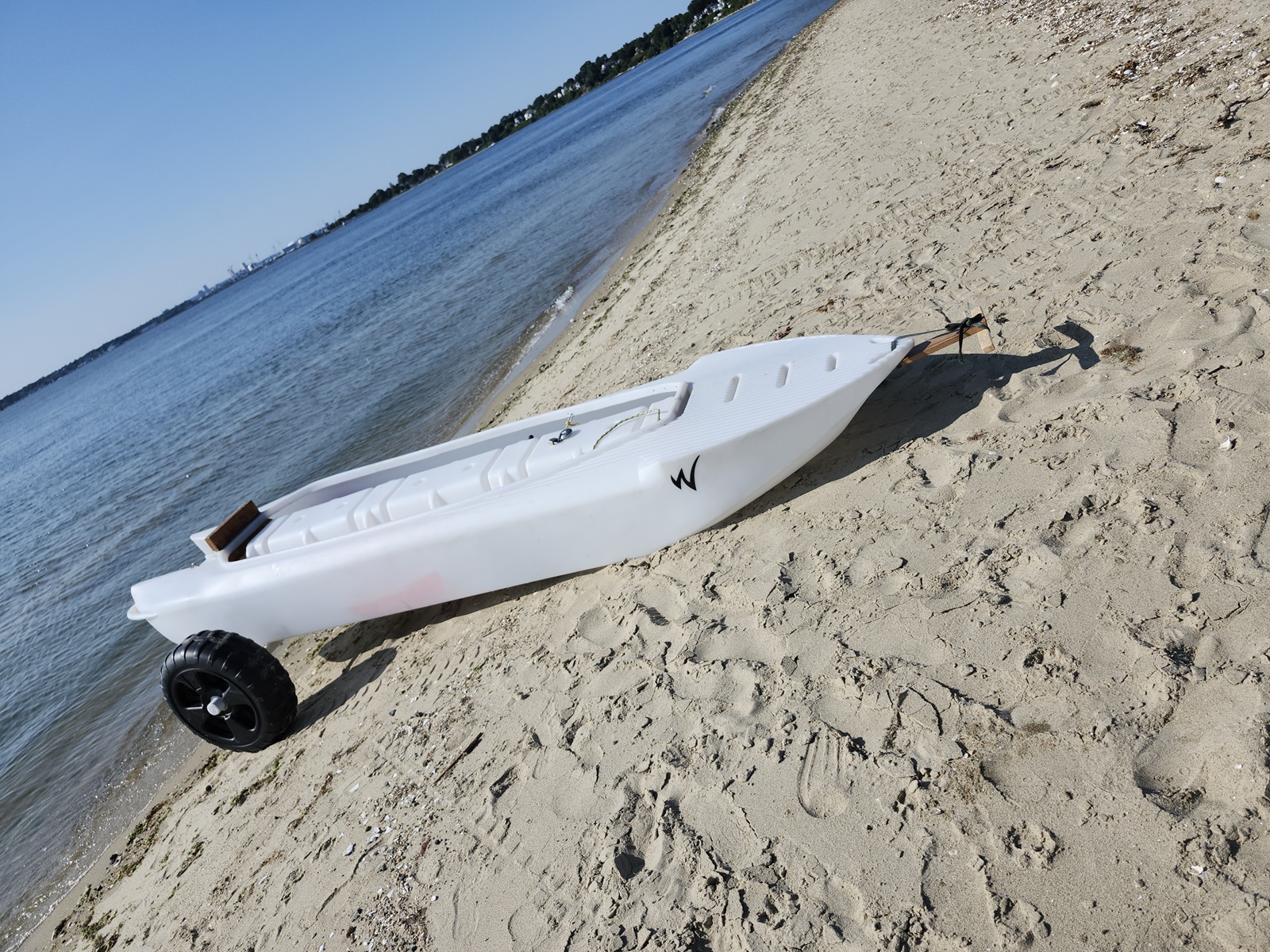 Boat uploaded on the wheel cart and attached to it, ready to be carried up the beach